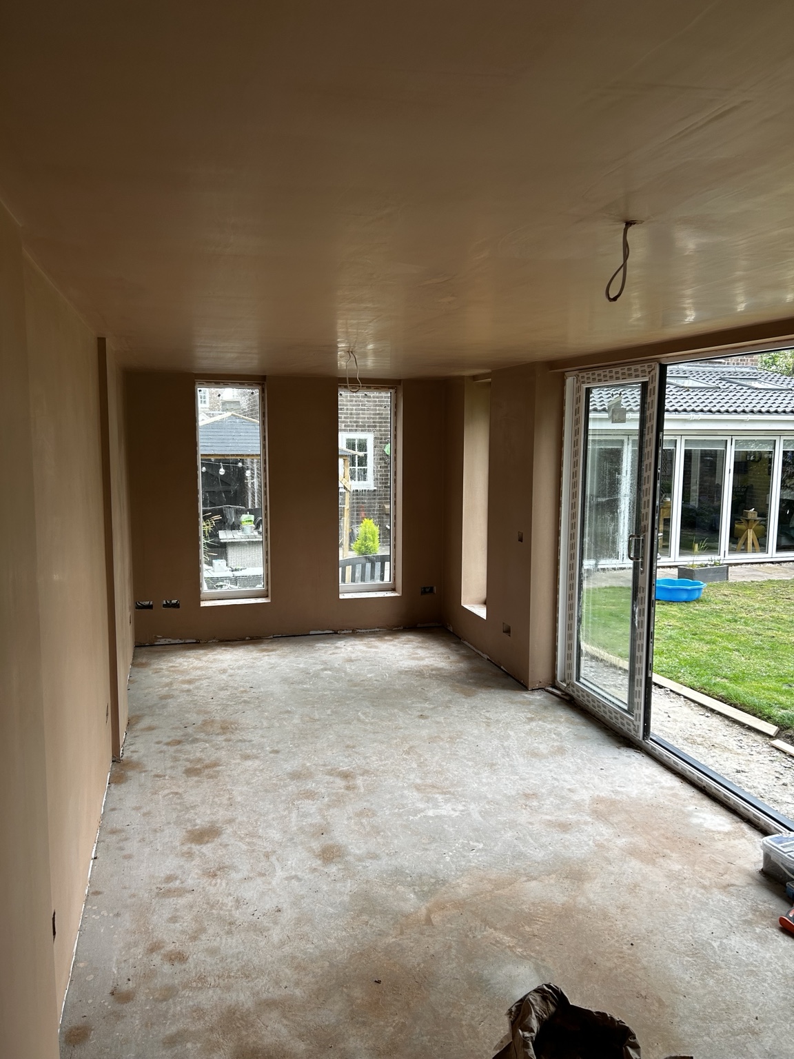 Finished plastered room with large windows